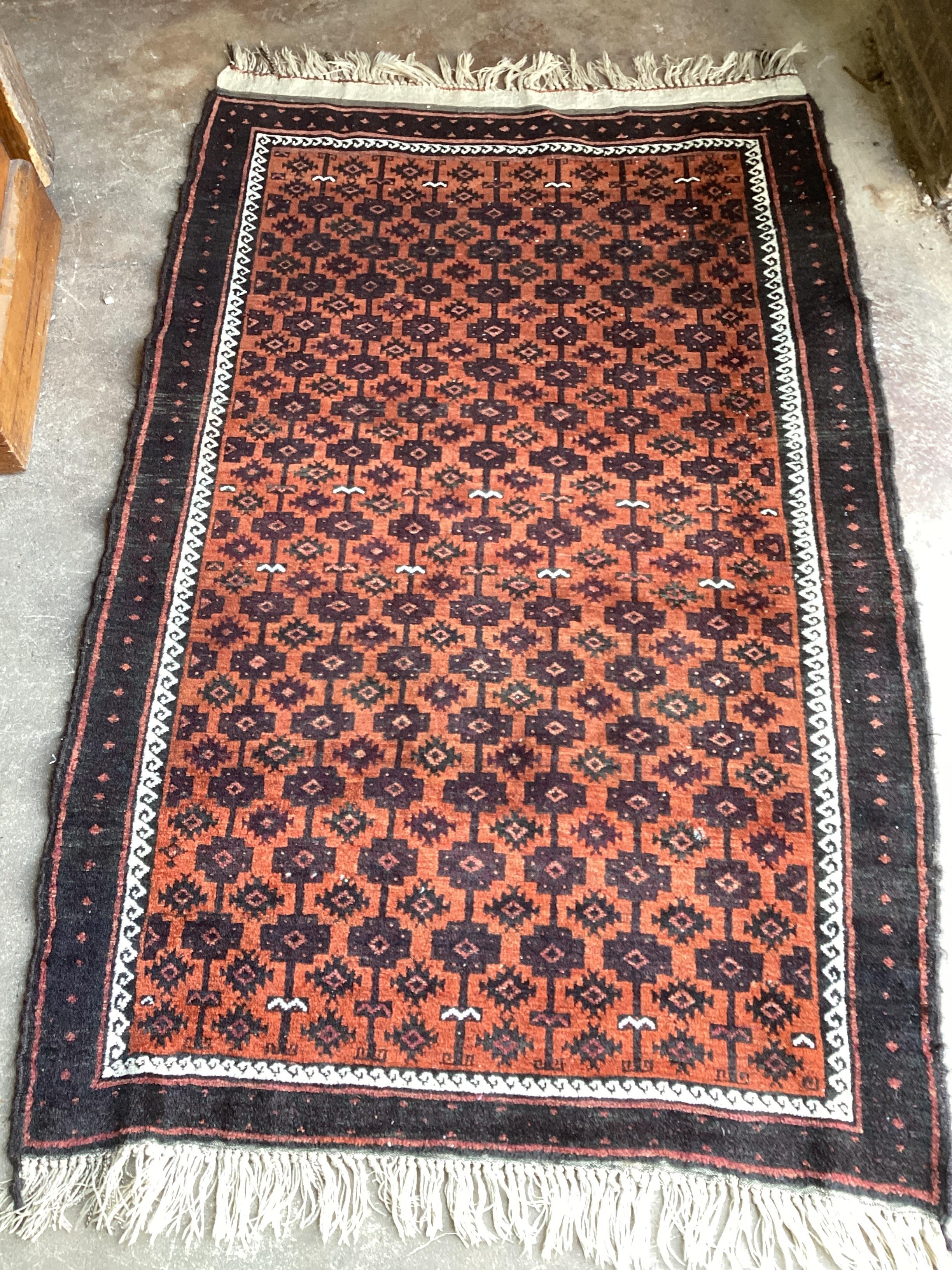 A Belouch red ground rug, 173 x 111cm